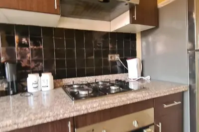 a kitchen with a stove and a counter top at appartement 2 chambres en plein centre ville gueliz marrakech in Marrakech