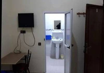 a bathroom with a sink and a tv on the wall at Dar ALBIDAWI in Marrakech
