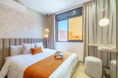 a bedroom with a bed with a teddy bear on it at Sérénité Tranquille Au Cœur du Centre Ville in Marrakech