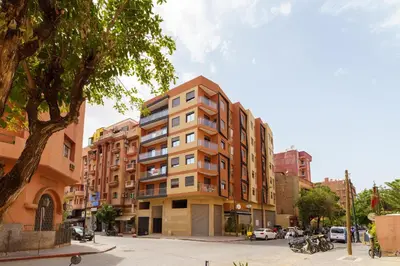 a tall building on a city street with buildings at Sérénité Tranquille Au Cœur du Centre Ville in Marrakech
