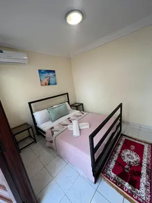 a bedroom with a large bed with pink sheets at Amazing 3 Bedroom Riad Marrakech in Marrakech