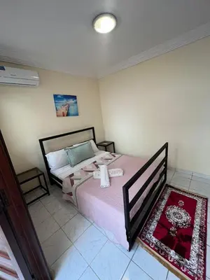 a bedroom with a bed with a pink blanket at Amazing 3 Bedroom Riad Marrakech in Marrakech
