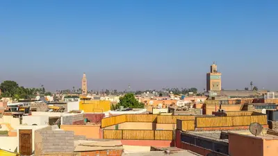 a view of a city with buildings and mosques at Riad Jarco Marrakech, cœur Medina, Rooftop, bassin , Proche Place Jemaa el fna in Marrakech