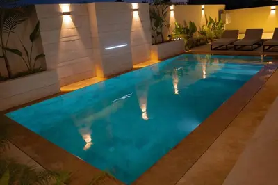 a swimming pool in a hotel at night at Villa Volubilis - Marrakech in Marrakech