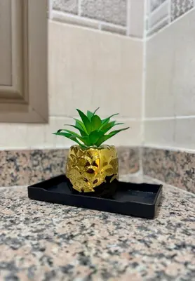 a pineapple planter sitting on top of a counter at The Blue Pearl - Fresh & Modern in Marrakech