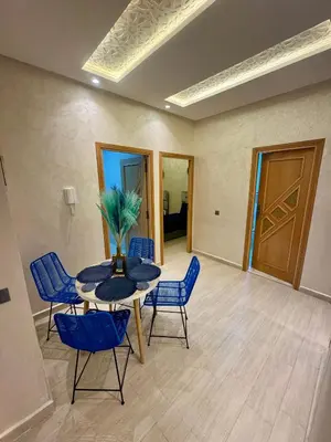 a dining room with a table and blue chairs at The Blue Pearl - Fresh & Modern in Marrakech