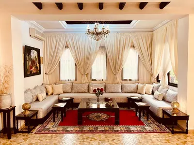 a living room with a couch and a table at Maison d'Hôte Angele in Sfiani