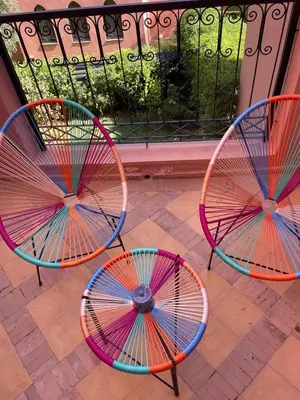 three colorful chairs sitting on top of a patio at Maison d'Hôte Angele in Sfiani