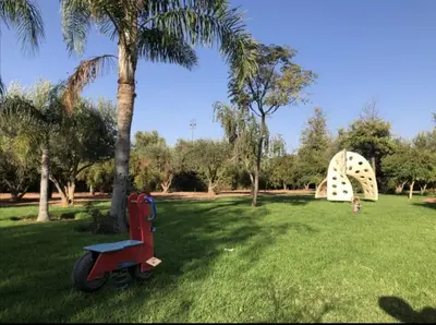 a child is playing in a park with a large object at Maison d'Hôte Angele in Sfiani