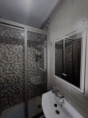 a bathroom with a sink and a shower at L'Oasis Lumineux avec Piscine et Terrasse in Marrakech