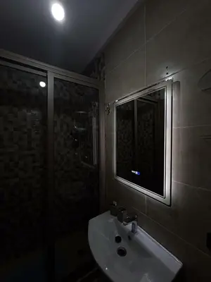 a bathroom with a sink and a glass shower at L'Oasis Lumineux avec Piscine et Terrasse in Marrakech