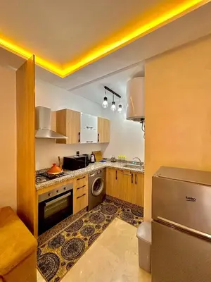 a kitchen with a stove and a dishwasher at L'Oasis Lumineux avec Piscine et Terrasse in Marrakech