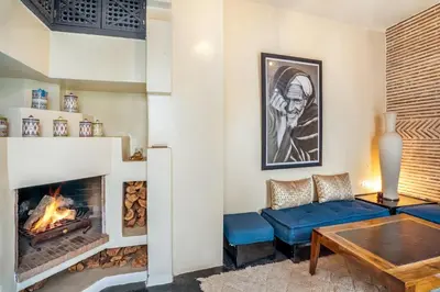 a living room with a couch and a fireplace at Riad EYNA Marrakech Medina in Marrakech