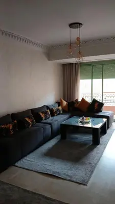 a living room with a couch and a coffee table at Marrakech appartement babylon2 in Marrakech