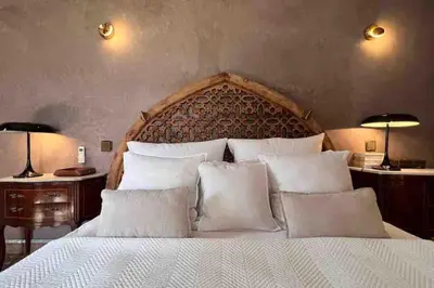 a bedroom with a large bed with white pillows at Villa d architecte Marrakech in Oulad Jellal