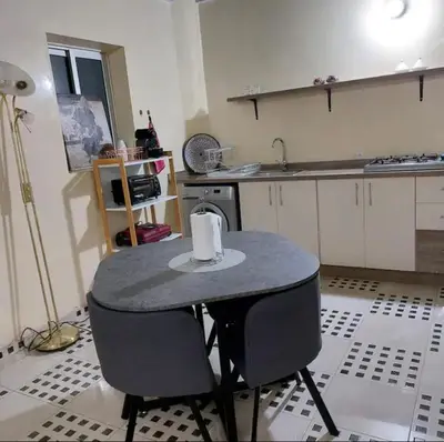 a kitchen with a table with two chairs and a sink at The Red Flat in Marrakech