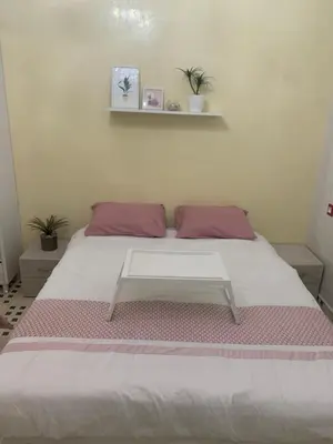 a bed in a room with a table on it at The Red Flat in Marrakech