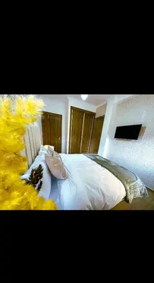 a bedroom with a bed with white sheets and pillows at Stylish Appartement in Marrakech in Marrakech