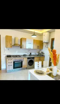 a kitchen with wooden cabinets and a white counter top at Stylish Appartement in Marrakech in Marrakech