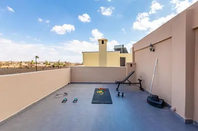 a gym on the roof of a house at Villa Gina, chic et Moderne avec piscine&terrasse in Marrakech
