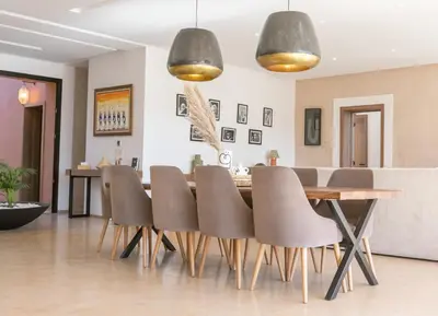 a dining room with a table and chairs at Dar Al Ikhwa, Lodge de luxe à Marrakech in Sfiani