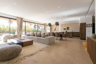 a living room with a couch and a table at Dar Al Ikhwa, Lodge de luxe à Marrakech in Sfiani