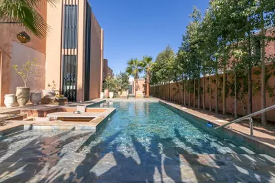 a swimming pool in the middle of a building at Dar Al Ikhwa, Lodge de luxe à Marrakech in Sfiani