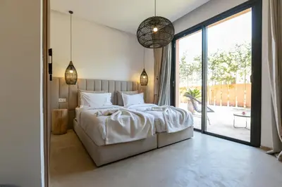 a bedroom with a large bed and a large window at Dar Al Ikhwa, Lodge de luxe à Marrakech in Sfiani