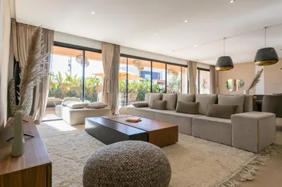 a living room with a couch and a table at Dar Al Ikhwa, Lodge de luxe à Marrakech in Sfiani
