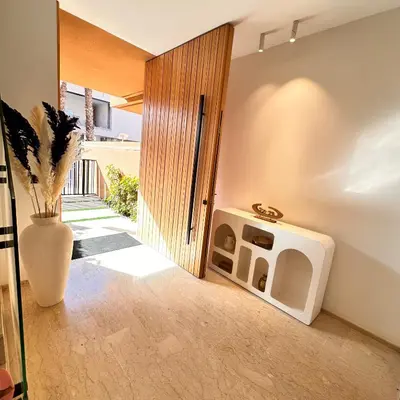 a room with an open door with a dog house at Villa Jassmir 5 chambres 10 min du centre piscine chauffée in Marrakech