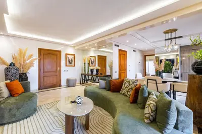 a living room with a couch and a table at Luxury 2-Bedroom Apartment in Hivernage Pool Residence Near Casino in Marrakech