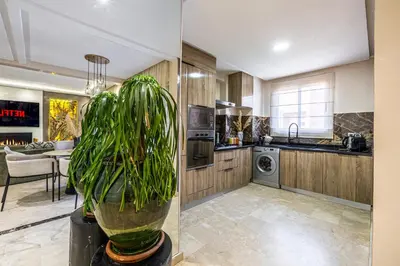 a kitchen with a plant in a pot next to a kitchen at Luxury 2-Bedroom Apartment in Hivernage Pool Residence Near Casino in Marrakech