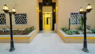 an entrance to a building with two lights and a hallway at Burj Malak appartement dans une résidence privée avec piscine in Marrakech