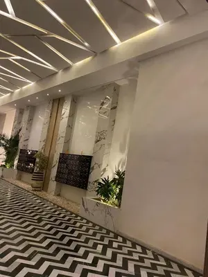 a lobby with a black and white checkered floor at Burj Malak appartement dans une résidence privée avec piscine in Marrakech