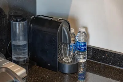 a coffee maker and bottles of water on a counter at Luxury Apartment in Marrakech in Marrakech