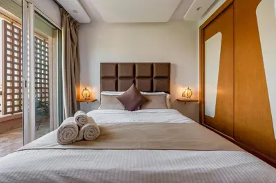 a bedroom with a large bed with towels on it at Luxury Apartment in Marrakech in Marrakech