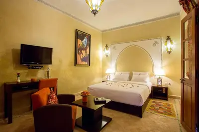 a hotel room with a bed and a tv at Riad Magda & Spa in Marrakech