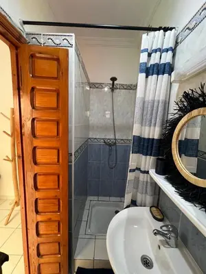 a bathroom with a sink and a shower at Riad Kinane Romann in Marrakech