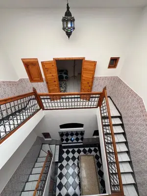 an overhead view of a spiral staircase with a light at Riad Kinane Romann in Marrakech