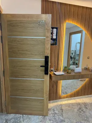 a wooden door in a room with a mirror at Luxueux Appartement-52 - Guéliz Marrakech in Marrakech