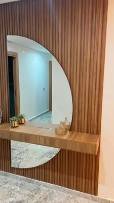 a mirror in a room with a wooden wall at Luxueux Appartement-52 - Guéliz Marrakech in Marrakech