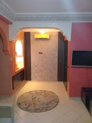 a living room with a round rug on the floor at Superbe Appartement 2 chambres à AL FADL Marrakech in Marrakech