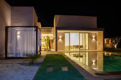 a home with a swimming pool and a house at Villa Chafti in Douar Khalifa Ben Mbarek