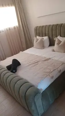 a bed with a hat sitting on top of it at Villa Chafti in Douar Khalifa Ben Mbarek