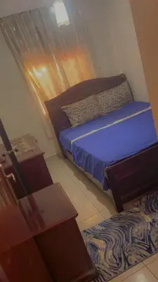 a small bedroom with a bed and a table at Mustapha in Marrakech