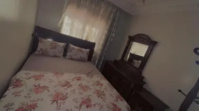 a bedroom with a bed with a dresser and a mirror at Mustapha in Marrakech