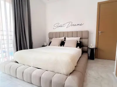 a bedroom with a large bed with a couch at Fun-filled luxury city center apartment in Marrakech