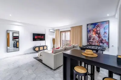 a living room with a couch and a table at Fun-filled luxury city center apartment in Marrakech