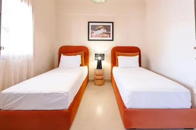two beds in a small room with at Merveille d'Art & Design - Marrakech Downtown in Marrakech