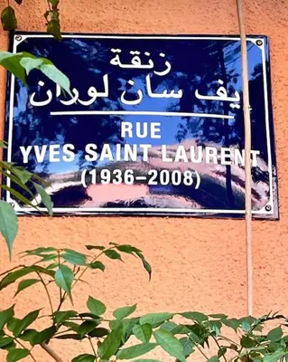 a sign on a building that readsrue was saint laurent at Top Appartement 1 Rue Yves Saint Laurent for 1-2 Per- Touristes International in Marrakech